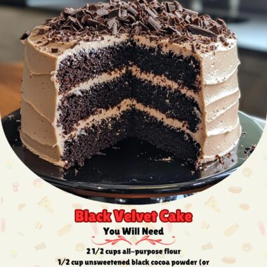 A slice of Black Velvet Cake on a white plate, garnished with chocolate shavings