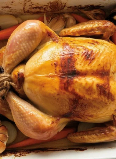 Perfectly roasted chicken with golden crispy skin, garlic, and herbs.
