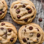 Baking chocolate chip cookie dough on a baking sheet ready for the oven.