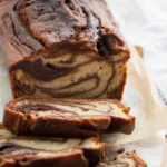 Delicious homemade loaf with a chocolate swirl, perfect for dessert or brunch.
