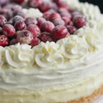 Elegant White Chocolate Cranberry Cheesecake with cranberry jam and white chocolate mousse layers