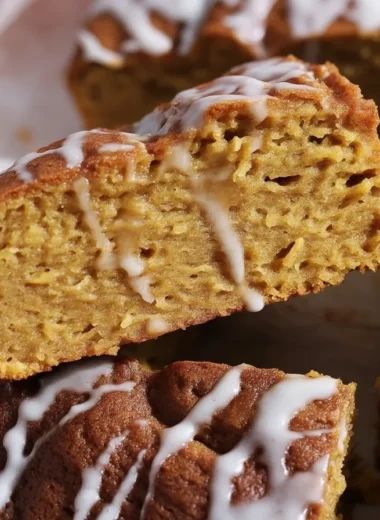 Cinnamon Roll Pumpkin Focaccia topped with vanilla glaze and cinnamon sugar filling.