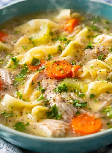 Delicious Instant Pot Chicken Noodle Soup with chicken, carrots, celery, and noodles.