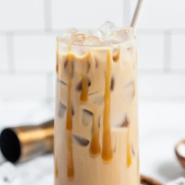 A delicious Salted Caramel White Russian cocktail served in a glass with caramel drizzle.