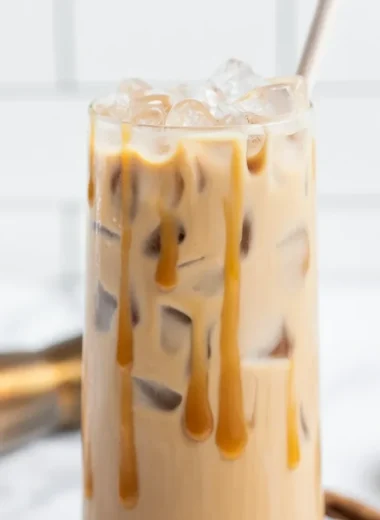 A delicious Salted Caramel White Russian cocktail served in a glass with caramel drizzle.