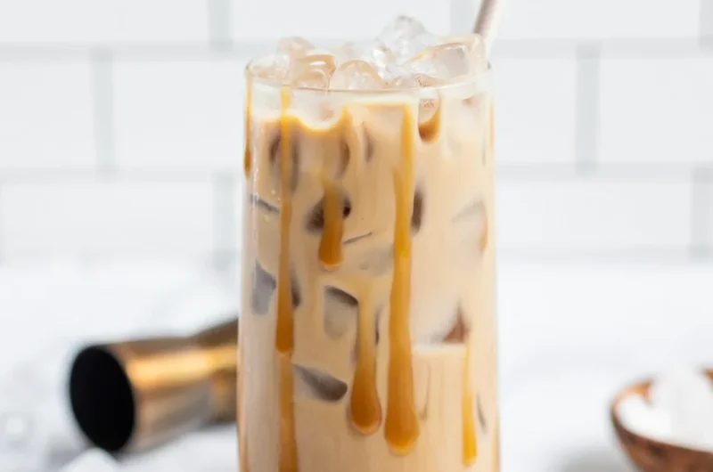 A delicious Salted Caramel White Russian cocktail served in a glass with caramel drizzle.