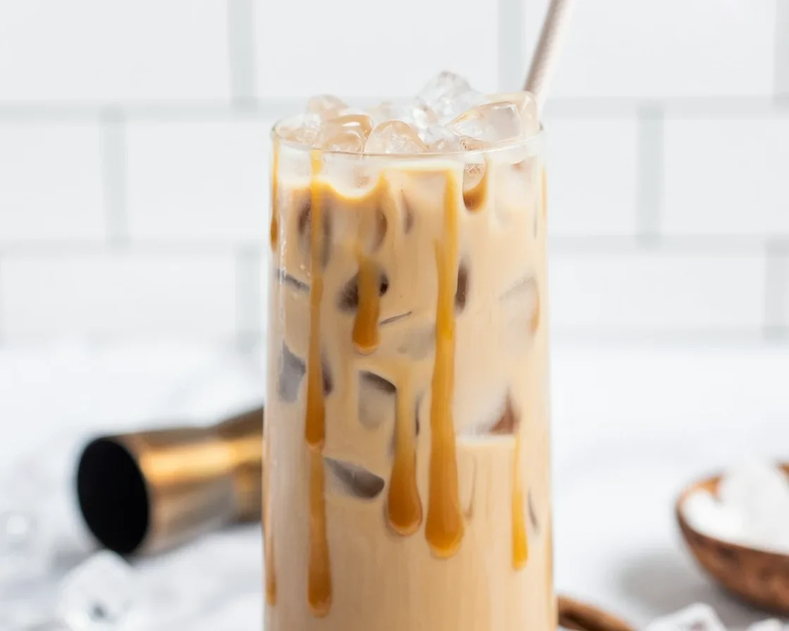 A delicious Salted Caramel White Russian cocktail served in a glass with caramel drizzle.