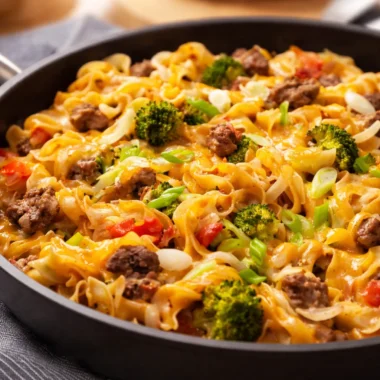 One-Pot Beef and Noodle Skillet with egg noodles, ground beef, and topped with cheese.