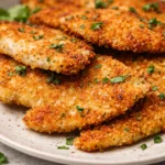 Crispy Baked Italian Parmesan Chicken garnished with fresh parsley on a plate