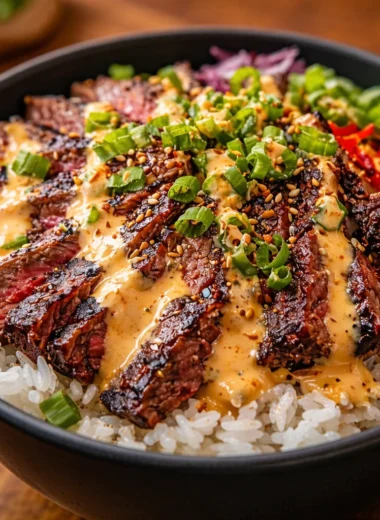 Korean BBQ Steak Rice Bowls with Spicy Cream Sauce, featuring tender steak and fresh vegetables.