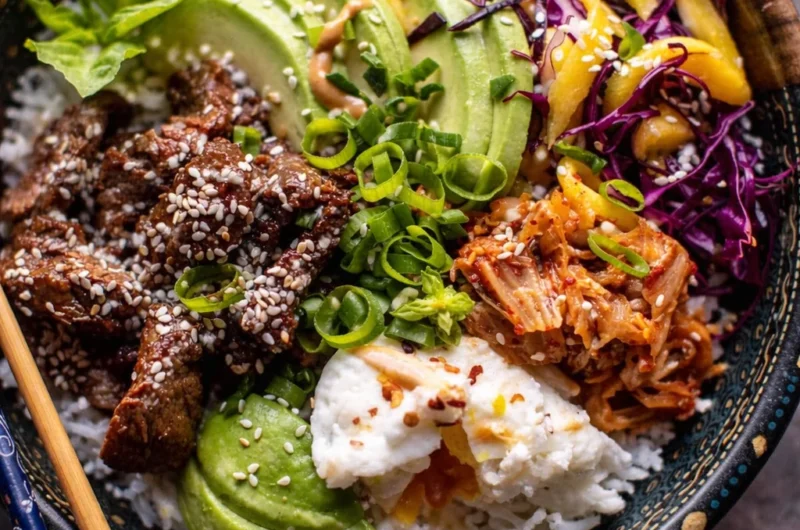 Delicious Korean BBQ Steak Bowls with tender beef, rice, and spicy sesame dressing.