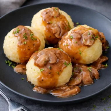Authentic Kartoffelklöße, traditional German potato dumplings served with gravy.