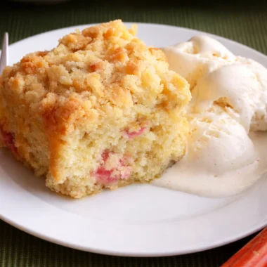 Slice of delicious German Rhubarb Streusel Cake (Rhabarber Streuselkuchen) served on a plate.