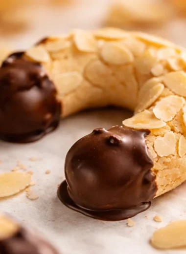Traditional German Almond Horns (Mandelhörnchen) - chewy almond cookies dipped in chocolate.